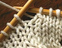 lift the slipped stitch over knitted stitch